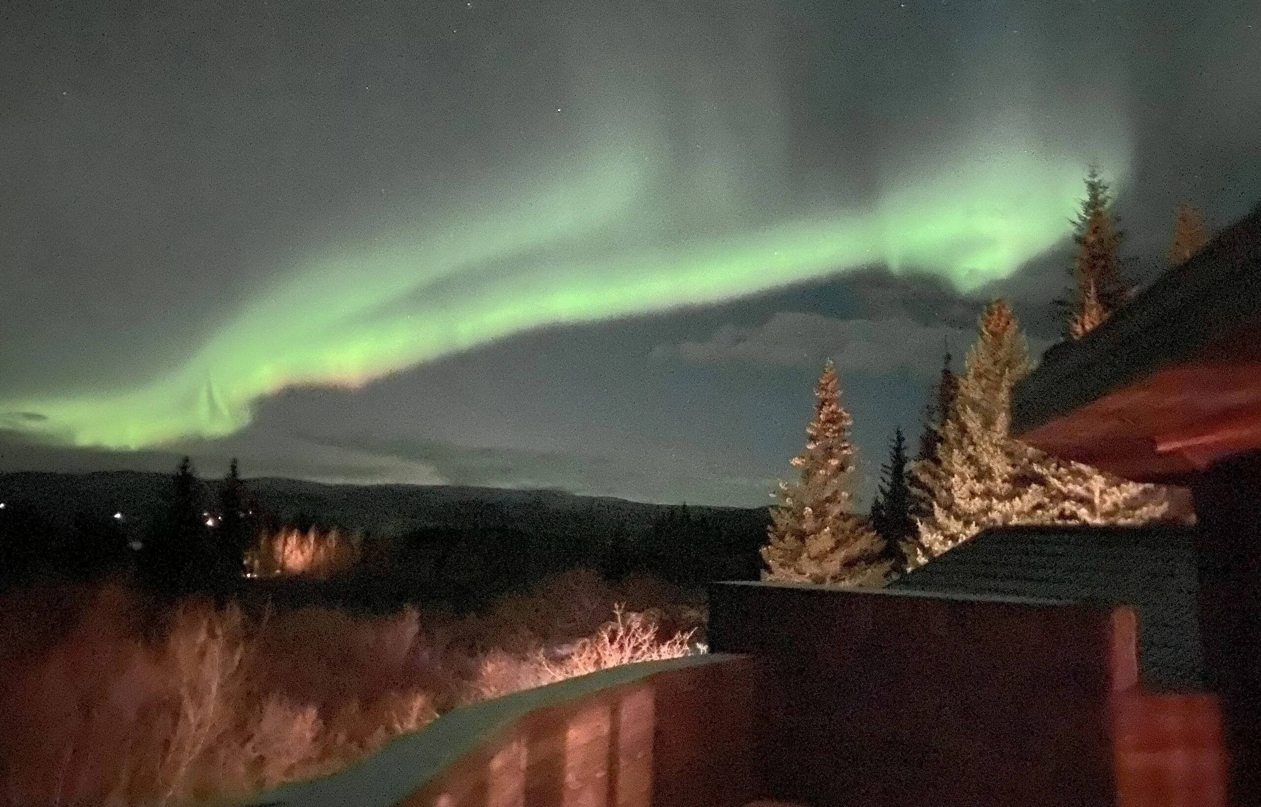 Northern lights over the lodge balcony